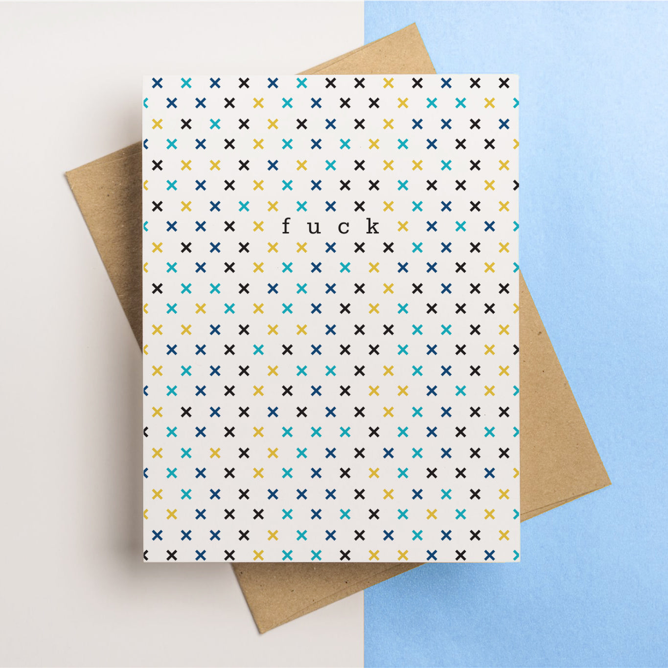 A sympathy greeting card that reads "Fuck" on the front side. An X pattern covers the front in a delightful color scheme.