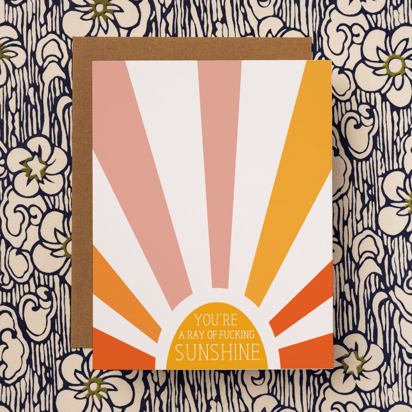 A sarcastic and unique everyday greeting card that reads "You're a ray of fucking sunshine." on the front side. Colorful sunshine illustration on note card.