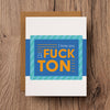 A funny love greeting card that reads "I love you a fuck ton"